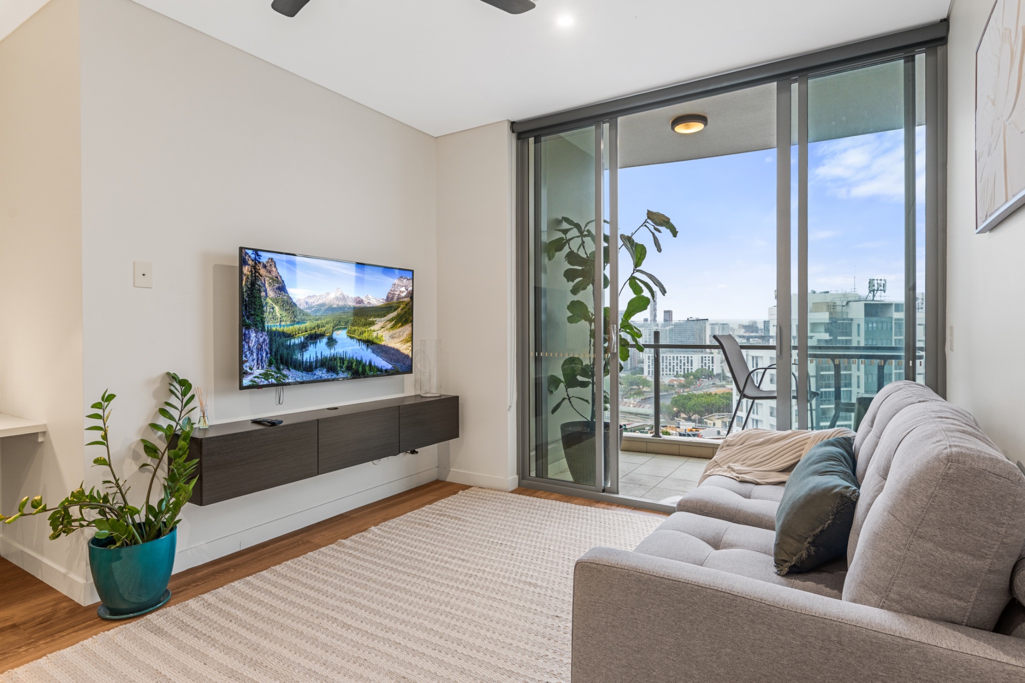Living room with television and balcony